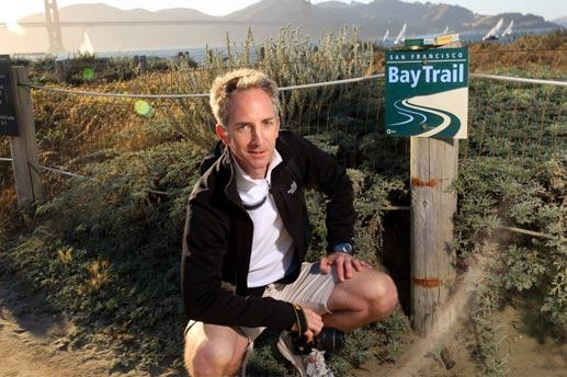 Man kneeling for a picture on the bay trail