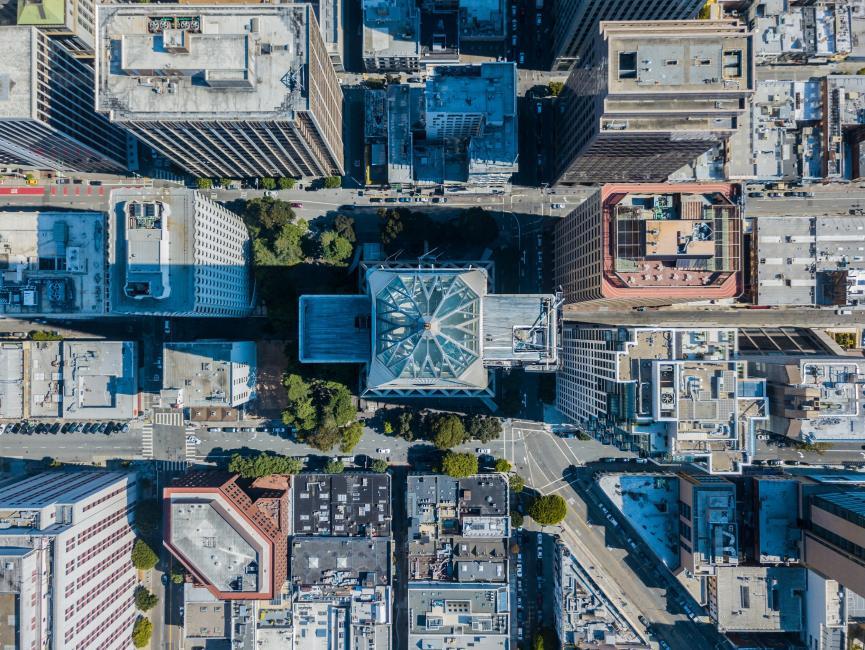 Aerial view of urban buildings, including the Transamerica Pyramid, in San Francisco.