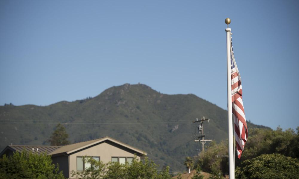 American flag with mountains in the background