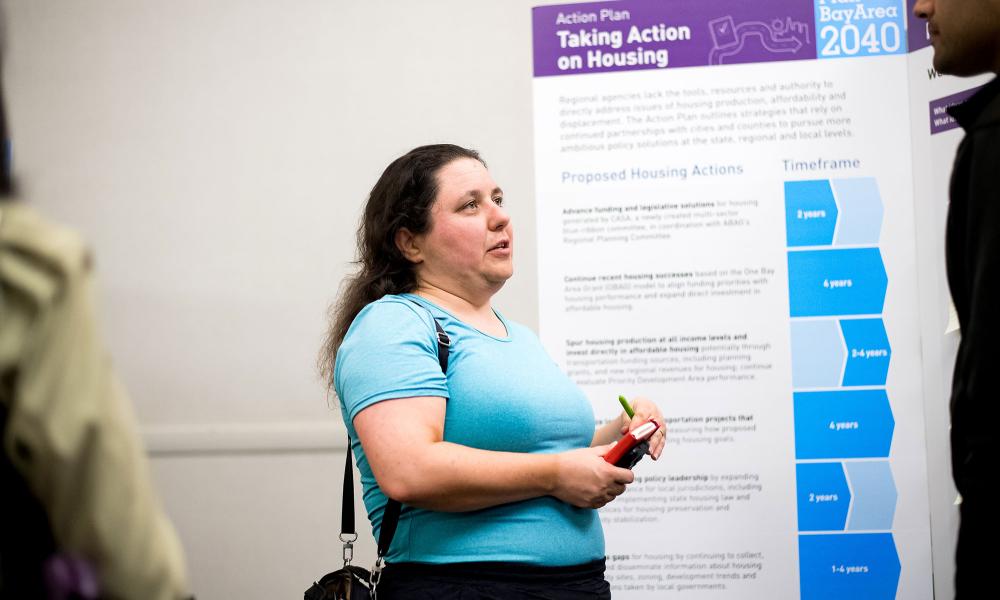woman talking in front of display boards