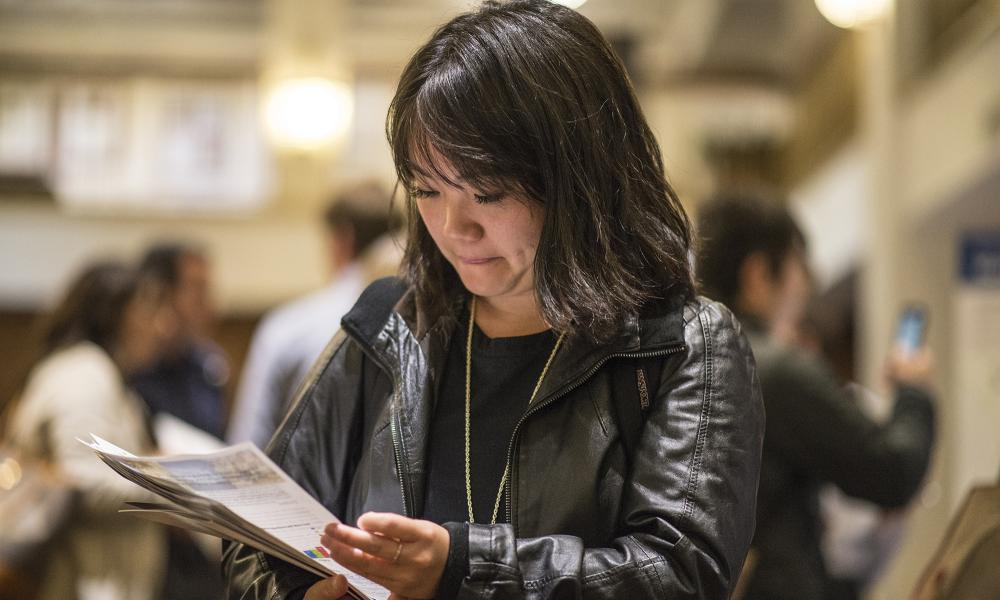 San Francisco resident Christina Wang looks through the handouts provided at the Plan Bay Area meeting in San Francisco at the Hotel Whitcomb, 6-14-16
