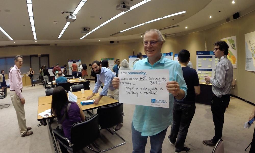 MTC Commissioner and President of the Alameda County Board of Supervisors Scott Haggerty holds up a sign at the Alameda County Plan Bay Area public outreach meeting in Oakland, 6-2-16
